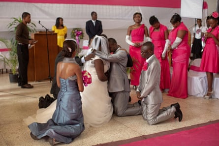 Vanessa Dorsainvil and Wesley Desir are surrounded by their godparents during a couple’s blessing at Shekinah Adventist church, during their wedding day in Port-au-Prince