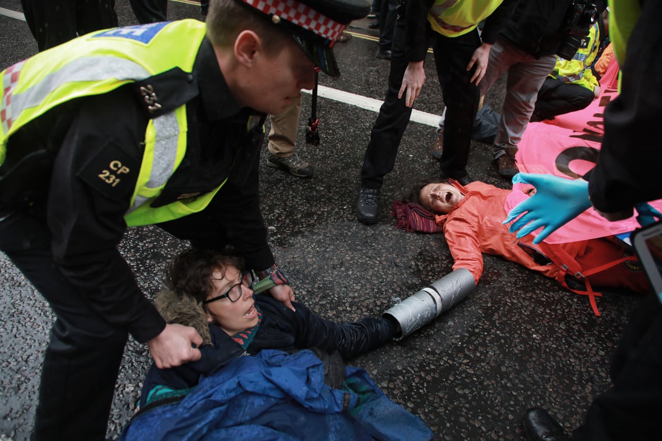 Activists lock themselves together and superglue themselves to the ground