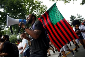 Luther Leonard holds an American flag in Pan-African colors during a Juneteenth Freedom March for Juneteenth, which commemorates the end of slavery in Texas, two years after the 1863 Emancipation Proclamation freed slaves elsewhere in the United States, in Seattle, Washington, U.S. June 19, 2020.
