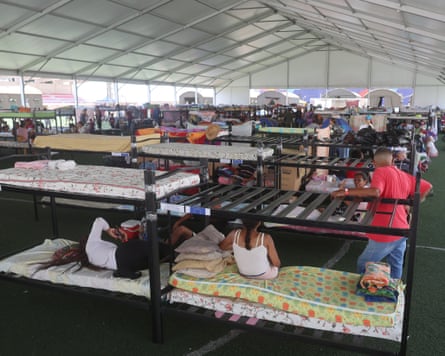 People take refuge at a sports centre in La Guaira, Venezuela.
