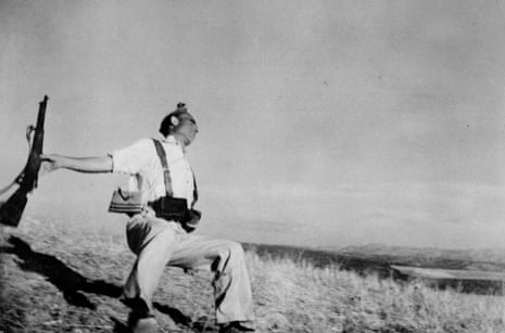 Black and white picture of a soldier holding a gun, falling down