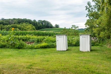 Outdoor toilets in a grassy field