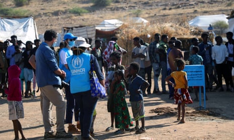 UNHCR personnel monitor food distribution at Um Rakuba refugee camp in Sudan, where Ethiopians fleeing the conflict in Tigray have taken shelter