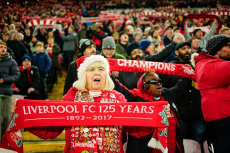 Liverpool's fans cheer for their team prior to the League Cup quarter-final between Liverpool and West Ham United.