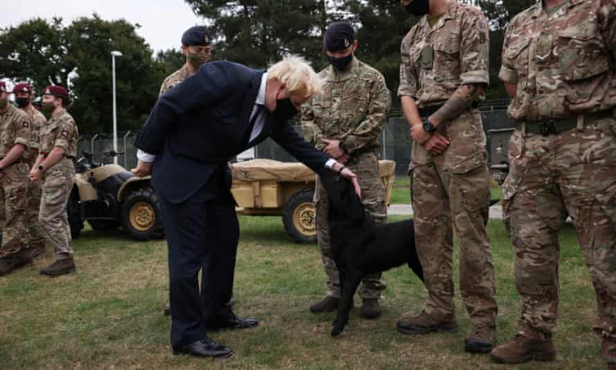 Boris Johnson meets with military personnel and Marlow, an army detection dog who worked in Afghanistan searching for IEDs, in September 2021.