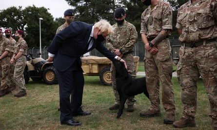Boris Johnson meets with military personnel and Marlow, an army detection dog who worked in Afghanistan searching for IEDs, in September 2021.