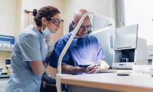 Dentists polishing dentures