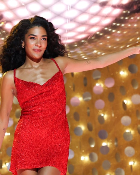 Olivia Dean on stage in a red dress