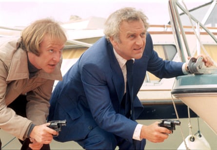 Dennis Waterman and John Thaw at a marina holding guns