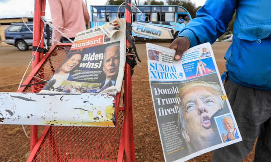 A news vendor in Kiambu, Kenya, offers a newspaper reporting on Joe Biden’s election win earlier this month.