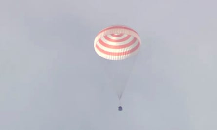 The Soyuz MS-19 space capsule parachutes to Earth in Kazakhstan on Tuesday.