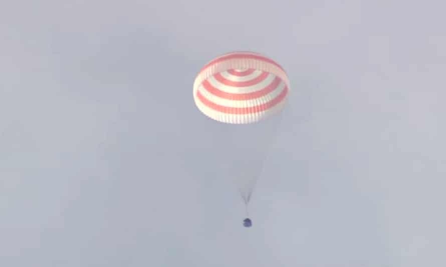 The Soyuz MS-19 space capsule parachutes to Earth in Kazakhstan on Tuesday.
