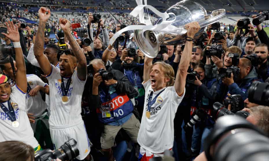 Luka Modric and his Real Madrid teammates celebrate with the Champions League trophy in Paris.