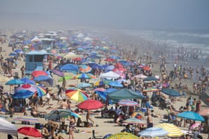 People cool off in the water on Huntington Beach, during record heat in California