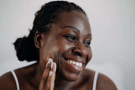A woman applying sunscreen