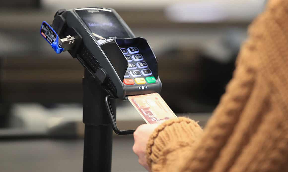 A customer pays for groceries at a supermarket