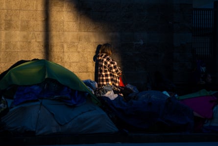 a light on a person standing by wall, with tents around them