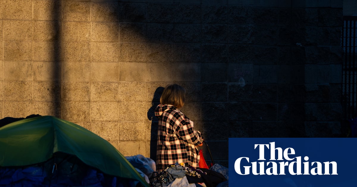 Shawn Pleasants, living proof that housing-first works, posing in front of city hall while HUD works overtime to make sure the next Shawn never gets a key, just a cot and a lecture.