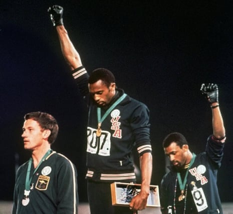 Australian Peter Norman, left, stands with US athletes Tommie Smith, centre, and John Carlos, during the playing of national anthem at the 1968 Olympic Games in Mexico City. 