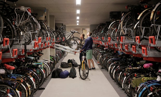 Two cyclists parks their bikes in the parking garage in Utrecht