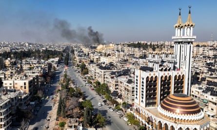 Smoke rising over Aleppo skyline.