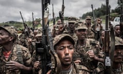 A group of Ethiopian federal soldiers with weapons pointing into the air.