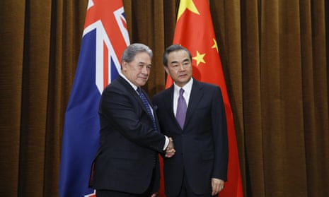 China’s foreign minister Wang Yi shakes hands with New Zealand’s foreign minister Winston Peters in Beijing on 25 May 