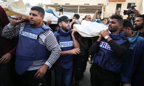 Journalists, relatives and friends carry the bodies of journalists Sary Mansour and Hassouna Sleem.
