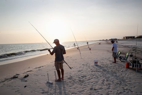people fish on a beach
