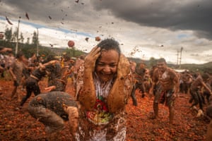 People throw tomatoes during the celebration of the 15th Colombian Tomato Festival on June 11, 2023 in Sutamarchan, Colombia