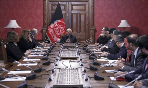 President Ashraf Ghani speaks to the US peace envoy Zalmay Khalilzad, third from left, at the presidential palace in Kabul.