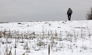 Mike Carpenter, uncle of Greg Longenecker, walks the field where Longenecker was killed by a bulldozer in 2018, in Bernville, Pennsylvania.