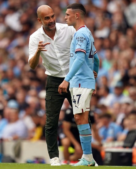 Manchester City manager Pep Guardiola issues instructions to Phil Foden during their Premier League match against Crystal Palace at the Etihad Stadium in August 2022.