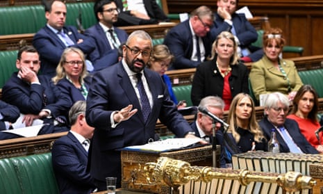 A handout photograph released by the UK Parliament shows Britain's Home Secretary James Cleverly making a statement on Statement on the UK-Rwanda partnership in the House of Commons.