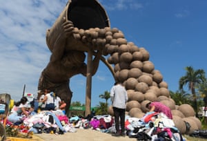 People search through clothes donated after flooding in Mexico