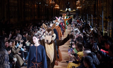 Performers in animal costumes join models on the catwalk