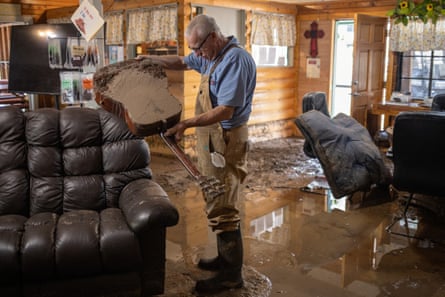 Manager of RV park empties flood water out of guitar in aftermath of fires in Ruidoso, New Mexico.