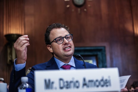 a man in a suit speaks into a microphone