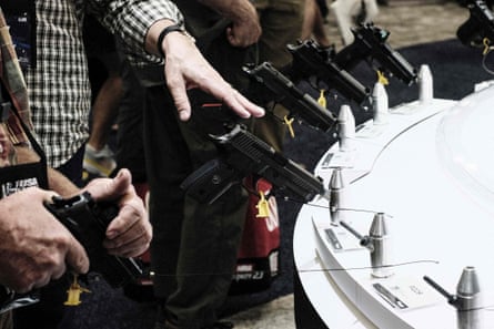People looking at handguns at an NRI convention