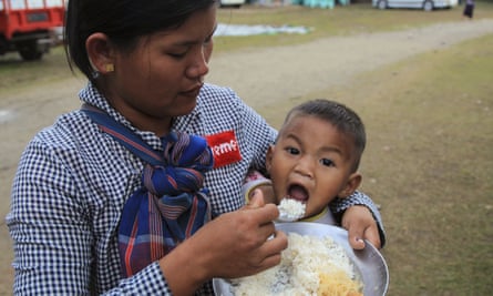 An ethnic Kachin woman feeds her child in compound of Trinity Baptist church camp for internally displaced people in Myitkyina.