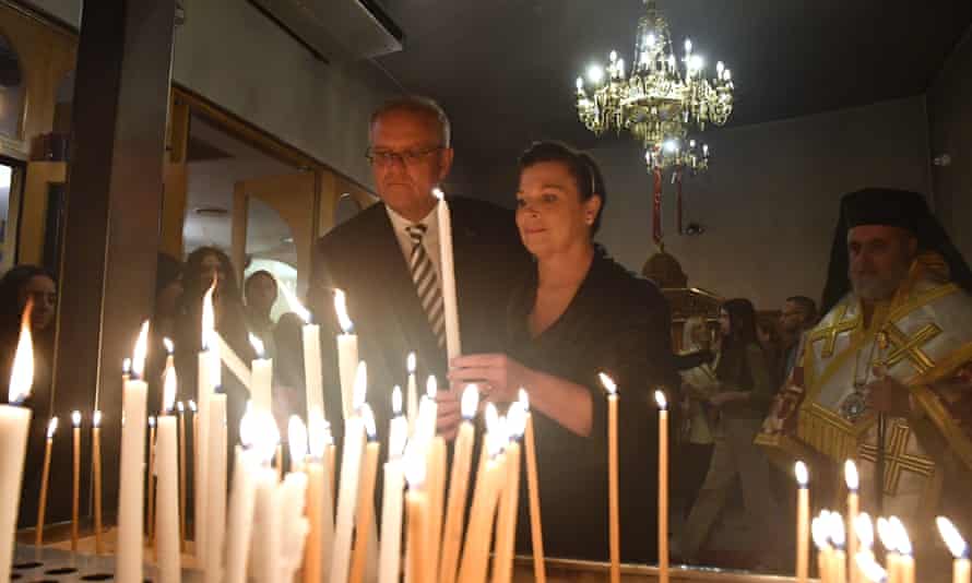 Prime Minister Scott Morrison light candles at Greek Orthodox Easter service on Day 14 of the 2022 federal election campaign.