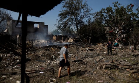 A man inspects his destroyed house after a Russian attack on Sloviansk