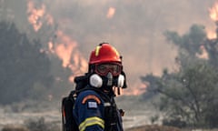 A firefighter looks on during a fire near the village of Vati, just north of the  town of Gennadi, in the southern part of the Greek island of Rhodes on 25 July.