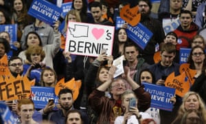 A woman holds a sign with an illustration of Washington during a Bernie Sanders rally.