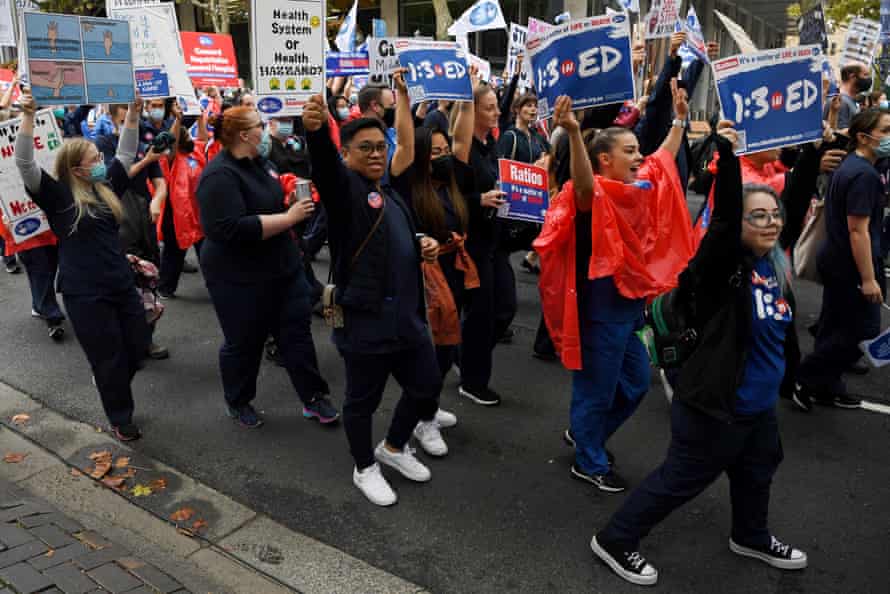 Nurses and midwives hold placards during a nurses strike rally at NSW Parliament House in Sydney in March.