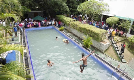 Protesters take a dip in the swimming pool at the president's official residence a day after it was stormed in Colombo, Sri Lanka.