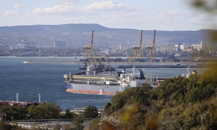 A view from a distance of a large oil terminal with a tanker moored at one of the berths
