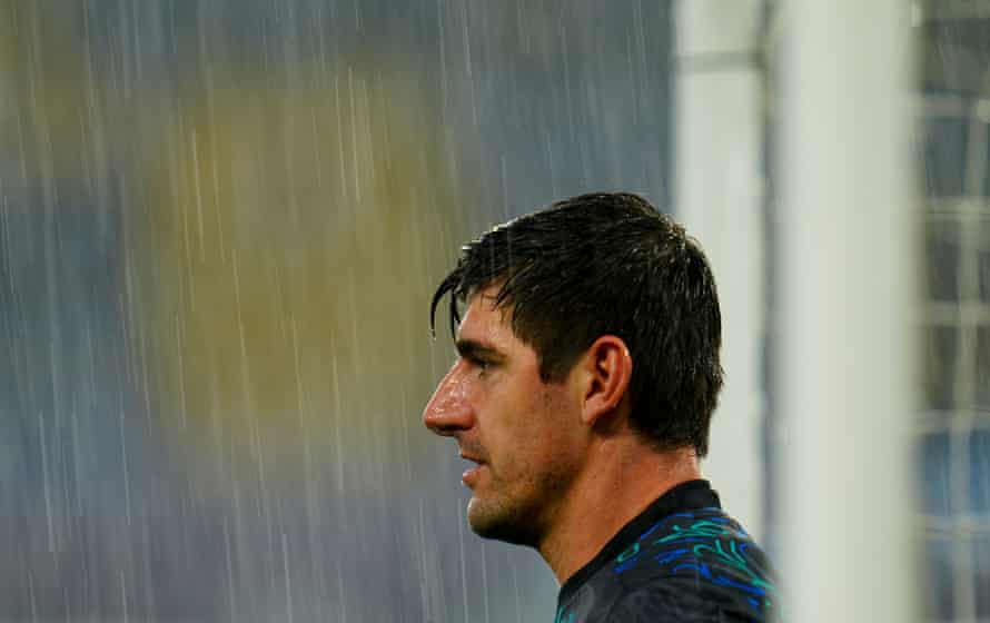Real Madrid’s goalkeeper Thibaut Courtois gets soaked during the warm up.