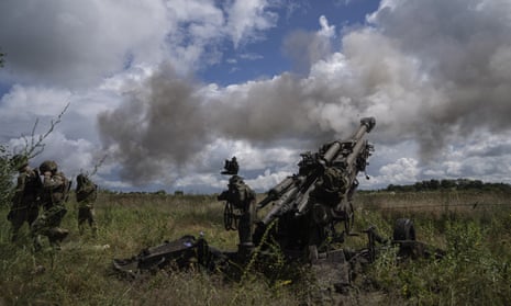 Ukrainian servicemen fire at Russian positions from a US- supplied M777 howitzer in Kharkiv region.
