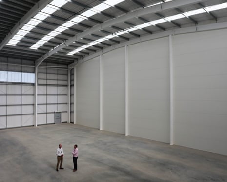 Two people in an empty warehouse at Segro Park in Rainham, Essex, in 2021.